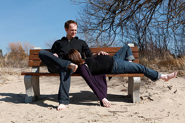 istock Expectant Couple on Bench at Beach 166429980