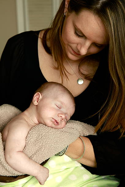 istock Mom Holding Newborn Baby 166433779