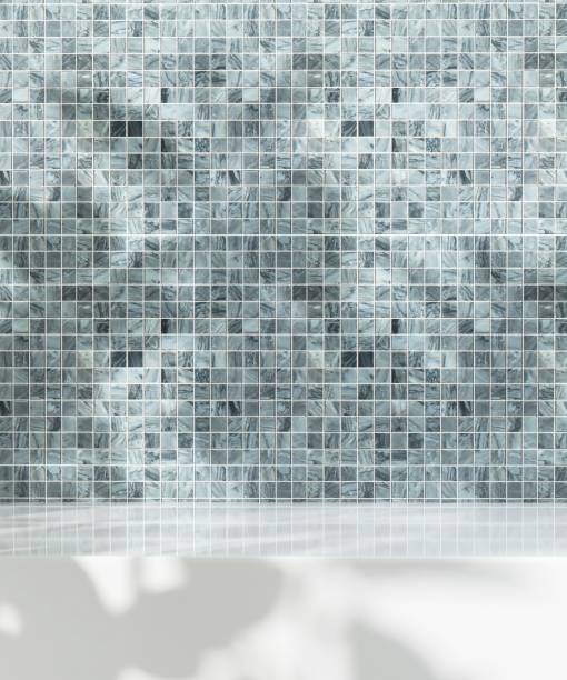 istock Minimal empty white stone counter table top in sunlight, leaf foliage shadow on blue marble mosaic tile wall 1664389451