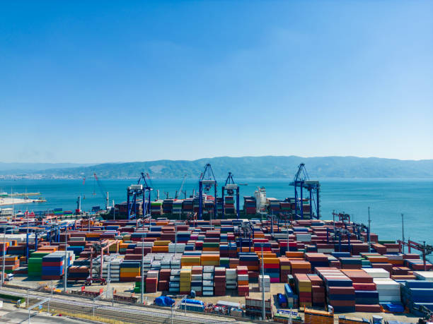 istock High angle view of  container cargo freight ship with working crane bridge  at import harbor, Kocaeli, Turkey 1664394072