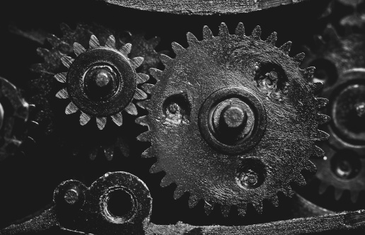 Old mechanism with pinions. Retro style black and white. Macro photo.