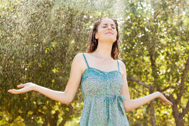 istock young woman enjoying under rain 166439531