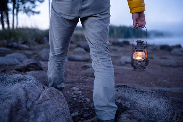 istock People and nature. Man with lantern at lakeshore. copy space. 1664400392