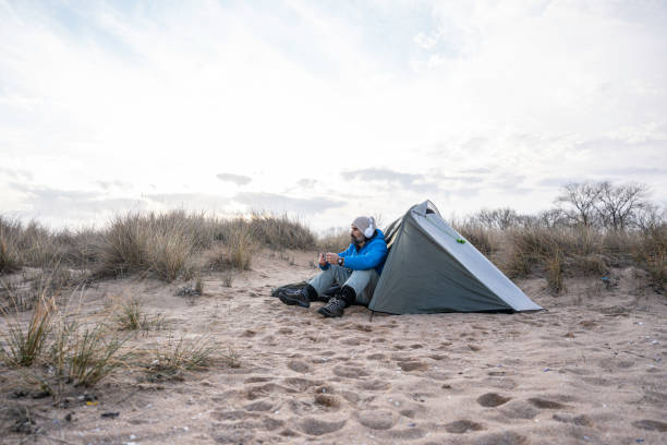 istock People and nature. Man camping at seaside. copy space 1664400395