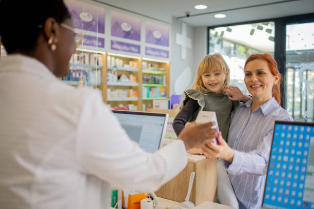 istock Mother and daughter at the pharmacy 1664403116