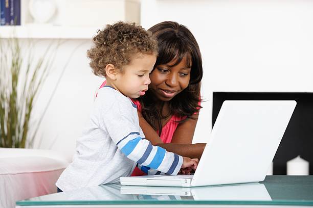 istock Toddler Using Laptop While Carer Watches 166440909