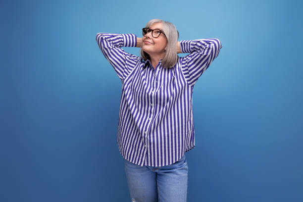 istock stylish mature old lady in a trendy shirt on a bright studio background with copyspace 1664409534
