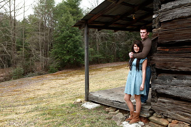istock Young Couple and Rustic Old Cabin 166441053