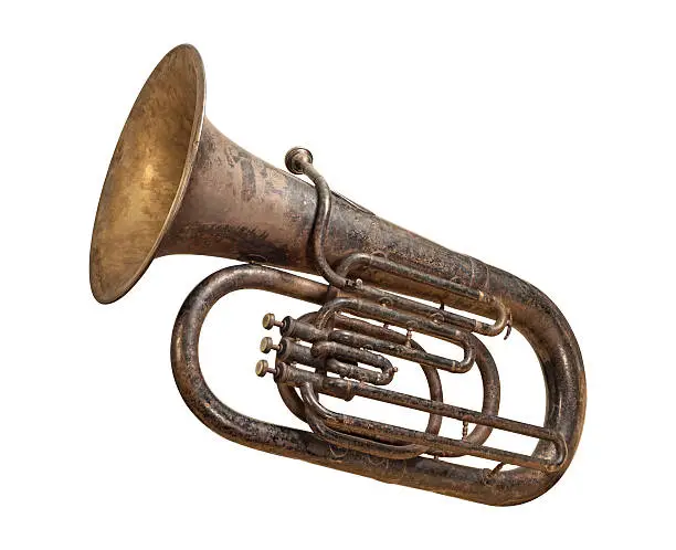 Antique Brass Tuba showing wear and tear from over the years.  The old age of the instrument provides discoloration and gives the horn character. The image is shown at an angle, and is in full focus from front to back. The image is isolated on a white background, and includes a clipping path.