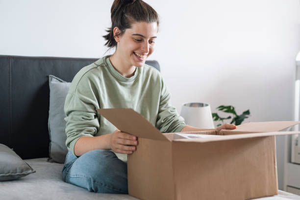 istock Happy and excisted woman opening parcel from online order. 1664416626