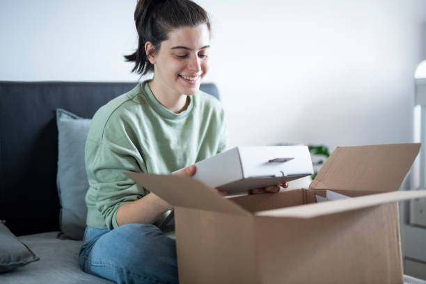 istock Happy and excisted woman opening parcel from online order. 1664416640