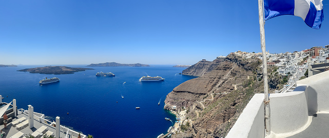 Fira, Greece - July 20, 2023: Cliffside buildings and walkways in the town of Fira on the island of Santorini in Greece