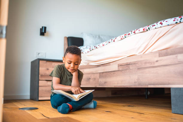istock Cute Mixed-Race Boy Nurturing Love for Books 1664431520