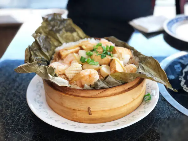 Mixed seafood sticky rice wrapped in lotus leaf