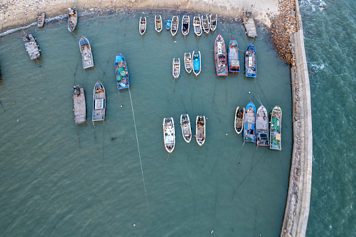 Dakar, Senegal - February 2, 2019: Colored, wooden, fisher  boats on the sandy beach of Dakar,   Africa