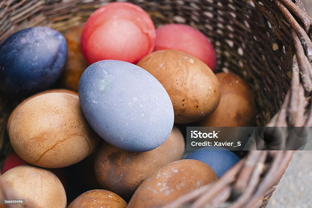 Esater eggs in a wicker basket. Coloured easter eggs. Backgrounds Stock Photo
