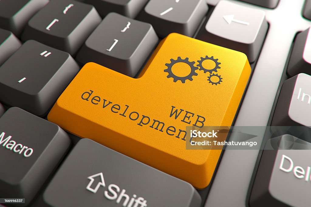 Keyboard with Web Development Button. Orange Web Development Button on Computer Keyboard. Internet Concept. Business Stock Photo