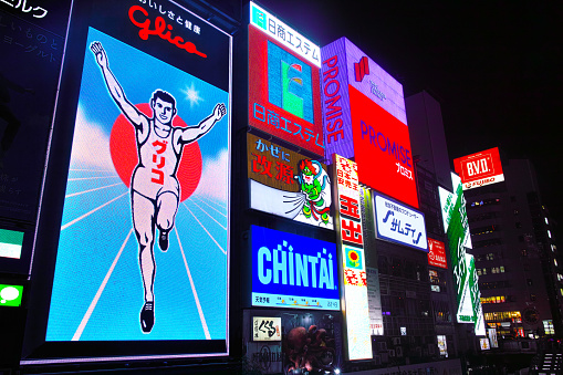 Scenery with tourist attraction signs along the Dotonbori River in Namba, Osaka at night