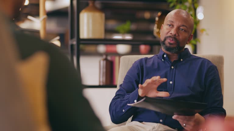 Bearded manager explaining business plans to colleague in modern office