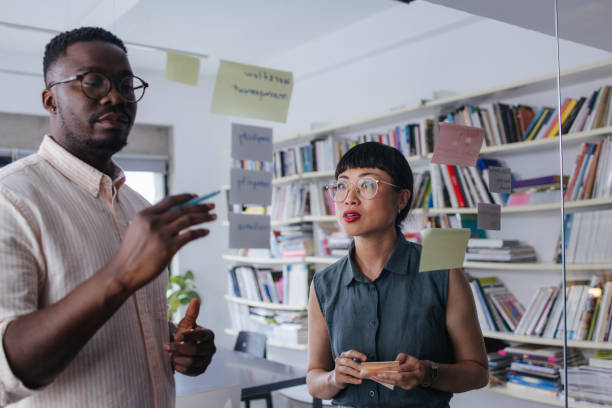 istock A Serious Businessman And His Coworker Working On Some Business Strategy Using Sticky Notes 1664543217