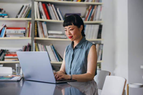 istock A Happy Beautiful Asian Businesswoman Using Her Computer While Working In The Office 1664544463