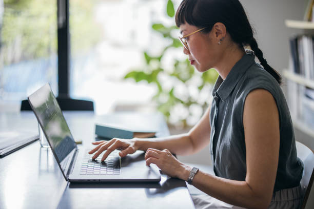 istock A Beautiful Asian Businesswoman With Glasses Using Her Computer While Working In The Office 1664544475