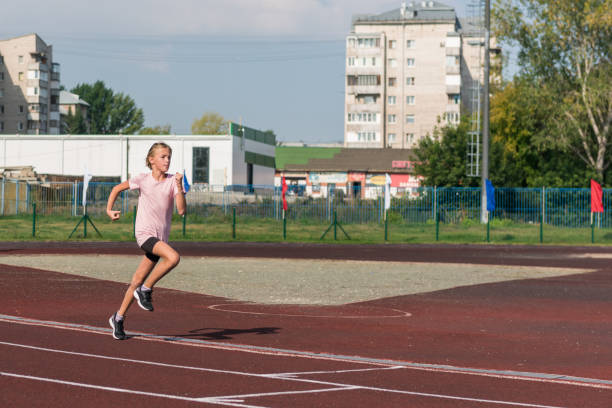 istock Young girl running on the running track 1664546721