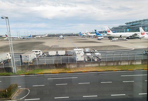 Heneda International AIrport tarmac and airplanes as seen from the International Arrivals area in Tokyo, Japan
