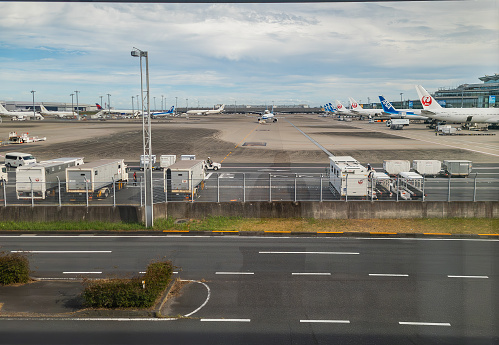 Heneda International AIrport tarmac and airplanes as seen from the International Arrivals area in Tokyo, Japan