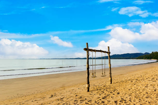 istock Swing with blue sky on Khao Lak beach Phang nga Thailand 1664557535