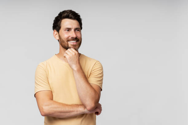 istock Handsome smiling bearded man looking at camera isolated on grey background 1664568088
