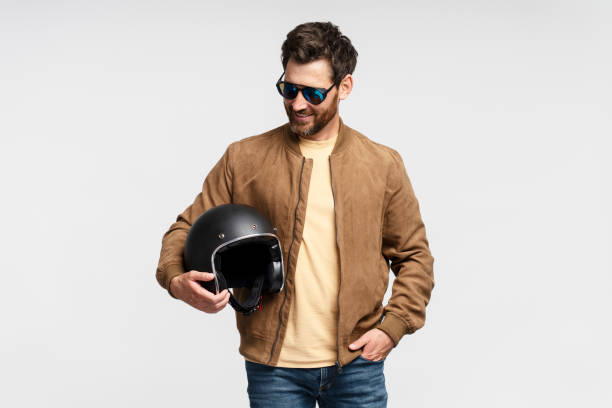 istock Handsome smiling bearded man, biker holding motorcycle helmet 1664568122