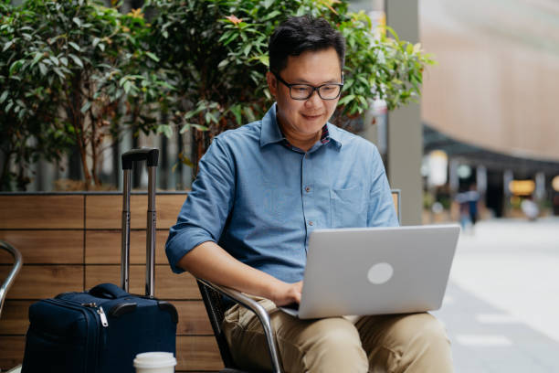 istock Business traveller using laptop in cafe 1664575027