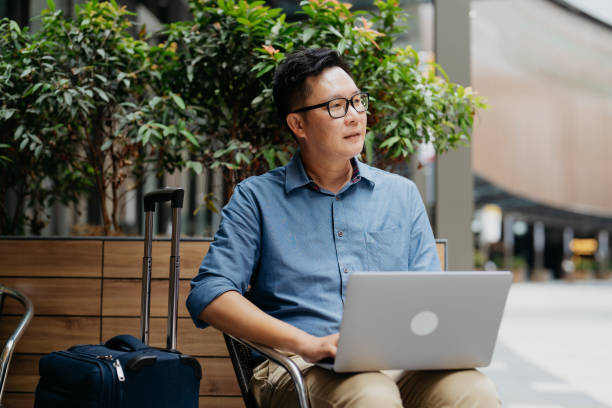 istock Business traveller using laptop in cafe 1664575031
