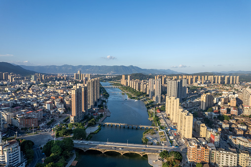 A bird's-eye view of the dense buildings in the city along the river。Aerial View of Dense Buildings in Cities Along the River, Xianyou, Fujian Province, China