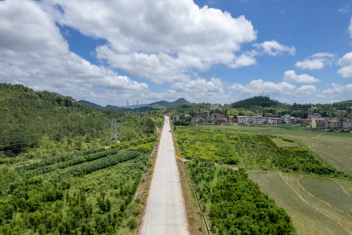 Sunny weather, aerial view of farmland, farmhouses, and roads on the plain