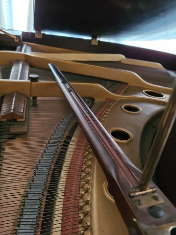 The interior of a baby grand piano