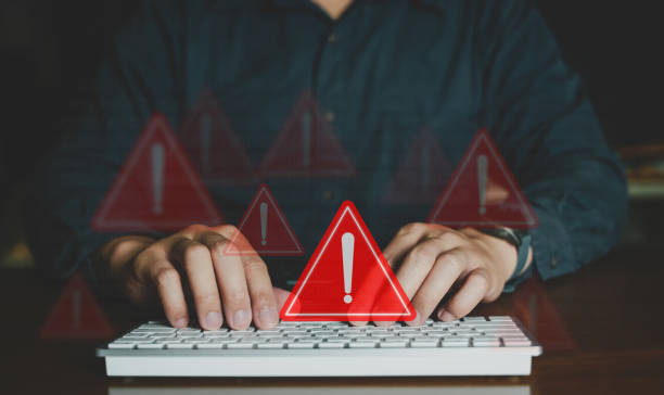 istock Emergency warning alert alarm on Smartphone, Data network protection, Virus alarm with people tapping keyboard and using computer. 1664628208