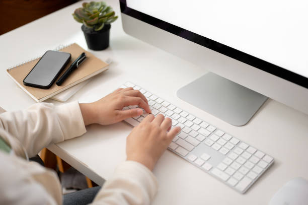 istock Close-up image of a female office worker typing on computer keyboard, working at her desk. 1664628732