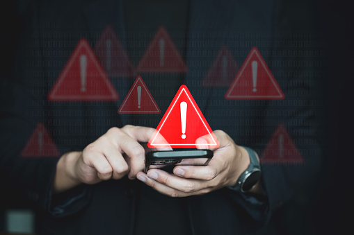 Emergency warning alert alarm on Smartphone, Data network protection, Virus alarm with people using application on smartphone.
