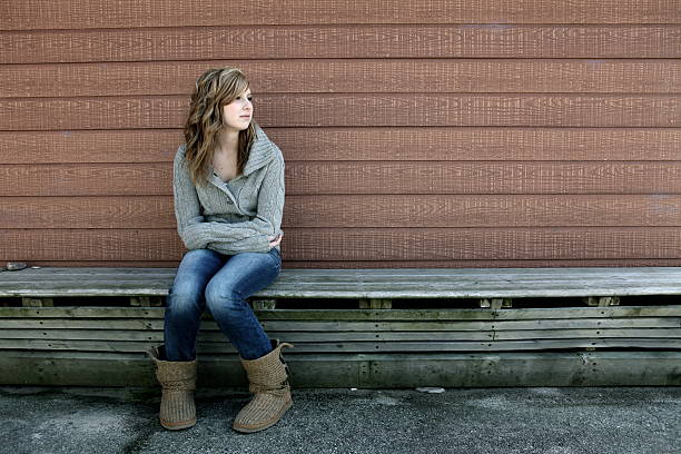 istock Teen Girl Alone on Bench 166473589