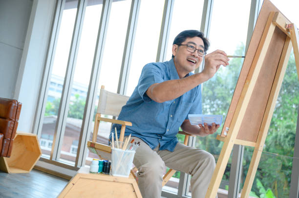 istock Smiling elderly man painting a vacation at home 1664739771