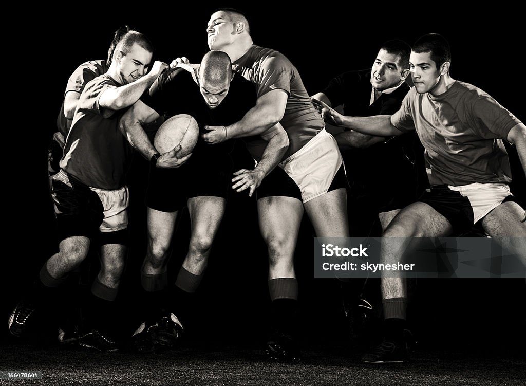 Rugby action. Black and white photo of rugby players in action. Isolated on black.    Rugby - Sport Stock Photo