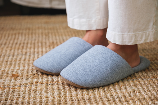 Closeup of a woman wearing slippers at home