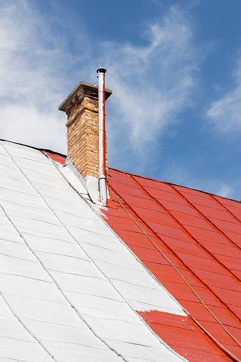 Painting old  tin house roof