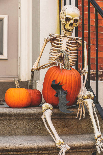istock a skeleton with a Halloween pumpkin 1664860758