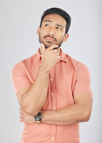 istock Face, thinking and asian man in studio for planning, decision or questions on grey background space. Idea, why and Japanese male model confused by choice, brainstorming or problem solving doubt emoji 1664886899