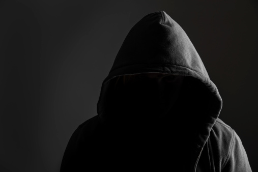 Creepy silhouette of a dangerous criminal wearing hoodie