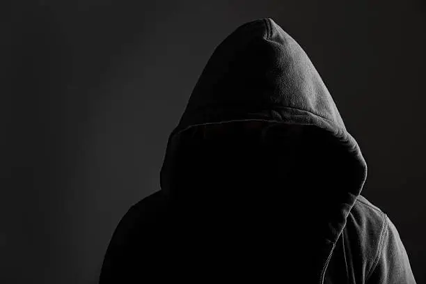 Creepy silhouette of a dangerous criminal wearing hoodie