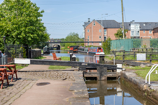 Canal Worcestershire. England, UK. Canal Narrow boats houseboats and barge are moored in a marina on a sunny day in spring. There are no visible people in the picture.